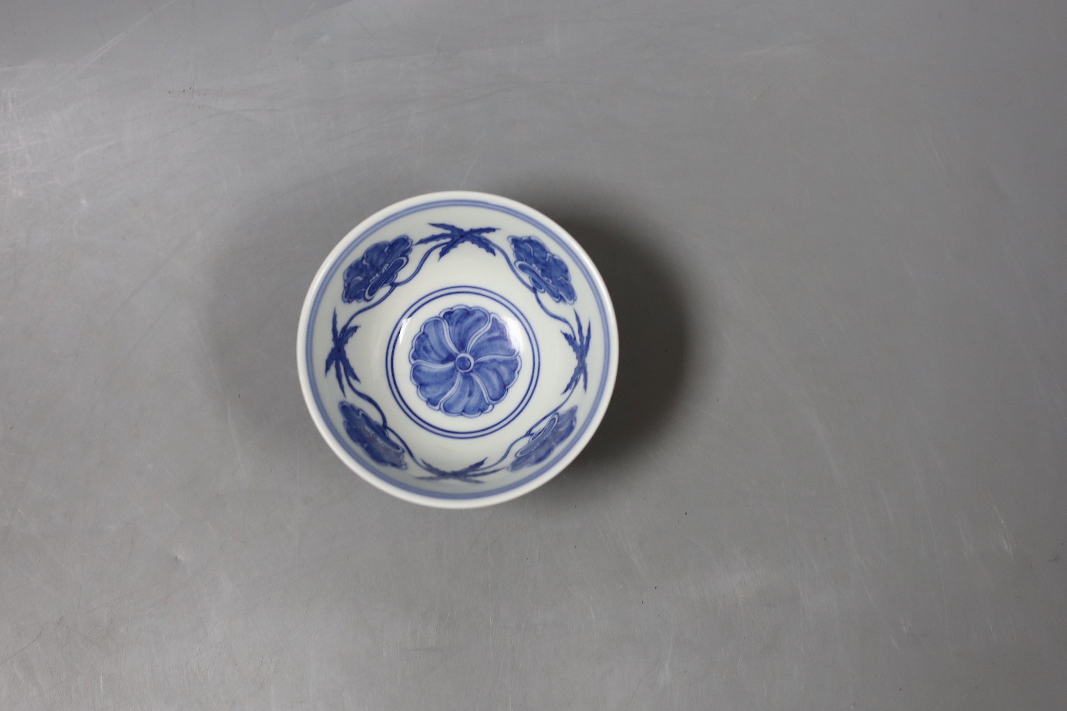 A Chinese blue and white circular bowl, inscription to base - 5cm tall